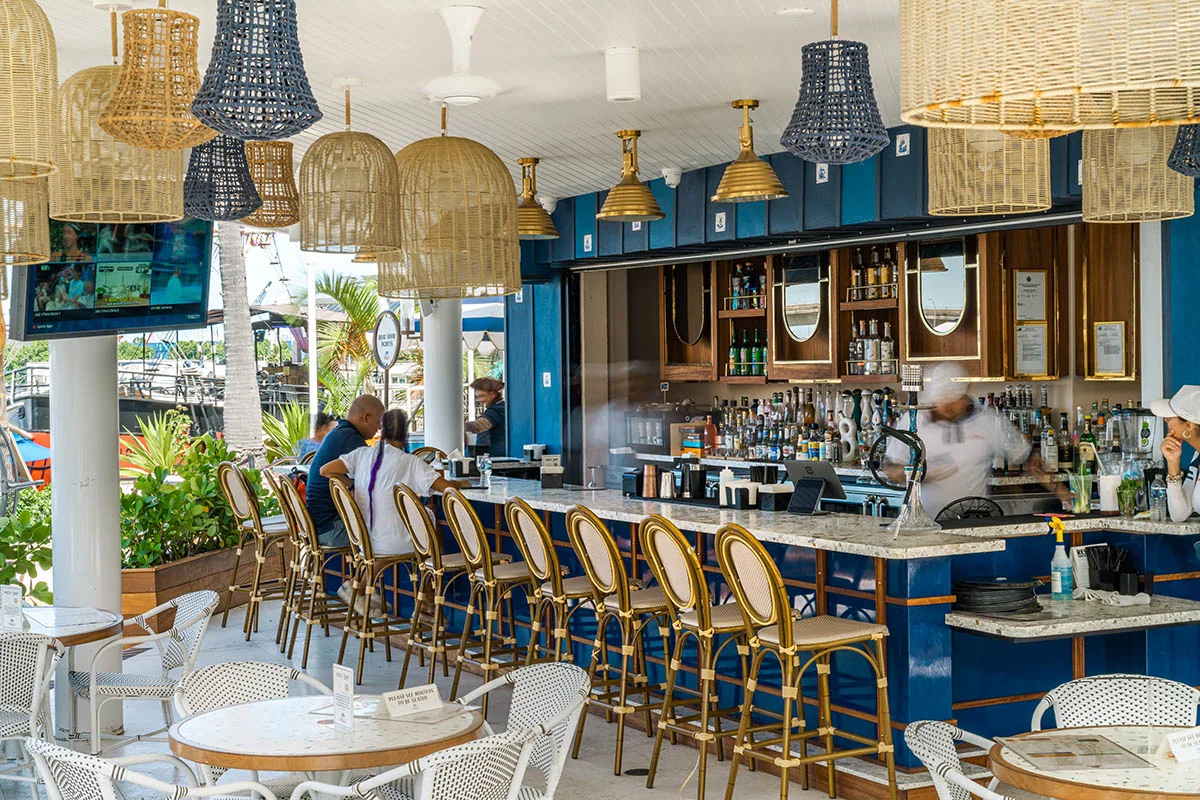 The blue Tequila y Mezcal bar at Pier 5, with woven pendant lights and guests at the counter