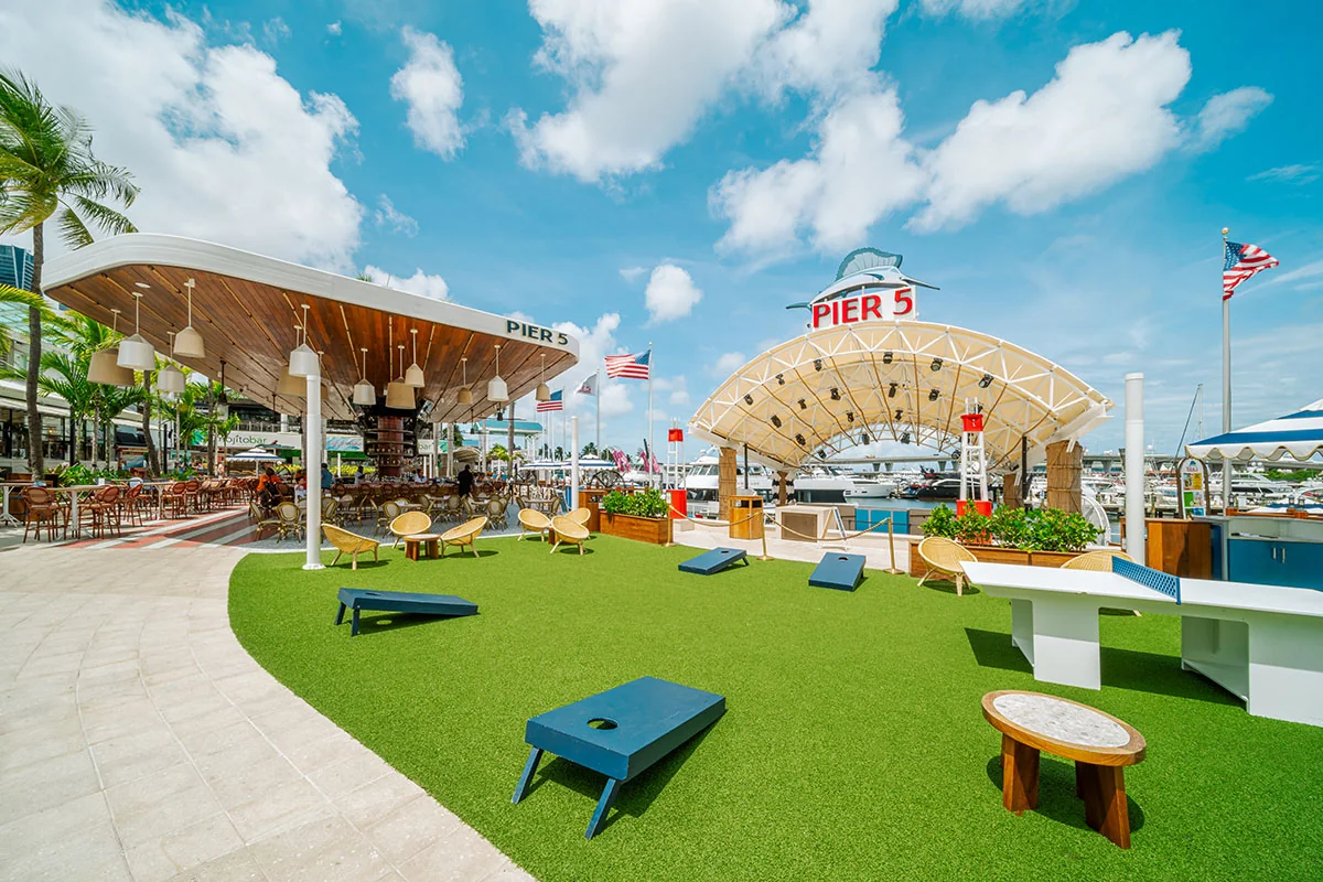 Pier 5’s open-air stage, lawn games and Rum Bar during the day at Bayside Marketplace